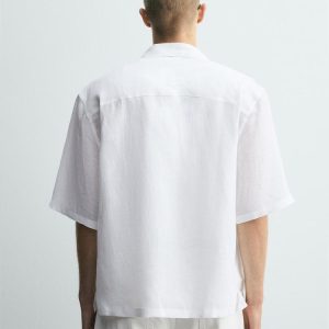 White short-sleeve button-down shirt and collar set, back view, with white pants.